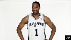 FILE - San Antonio Spurs' Tracy McGrady waits to be photographed in his new Spurs basketball uniform on Wednesday, April 17, 2013, in San Antonio. 