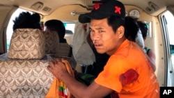 An injured man sits inside a vehicle in Muse, northern Shan state, Myanmar Saturday, May 12, 2018. Myanmar officials say an ethnic rebel group has launched an attack against the country’s military in the northern town, causing casualties. 