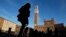 FILE - A woman walks at Del Campo square in Siena, Italy, March 12, 2012.