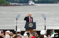 FILE - President Donald Trump gestures to the crowd after speaking during a rally at Rivertowne Marina, June 7, 2017, in Cincinnati, Ohio.