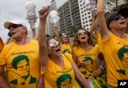 FILE - Demonstrators wear jerseys with the face of Judge Sergio Moro, who is heading the Petrobras investigation, as they protest on Copacabana beach in Rio de Janeiro, Brazil, March 13, 2016.