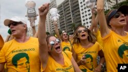 FILE - Demonstrators wear T-shirts with the face of Judge Sergio Moro, who is heading the Petrobras investigation, as they protest against government corruption on Copacabana beach in Rio de Janeiro, Brazil, March 13, 2016. 