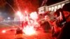 Flares go off in front of a Kenosha Country Sheriff vehicle as demonstrators take part in a protest following the police shooting of Jacob Blake, a Black man, in Kenosha, Wisconsin, Aug. 25, 2020. 