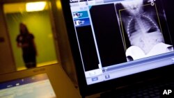 FILE- A radiology technician looks at a chest X-ray at Upson Regional Medical Center in Thomaston, Ga., Feb. 9, 2018. The Trump administration is trying to put an end to surprise medical bills.