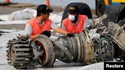 Para penyelidik Komisi Nasional Keselamatan Transportasi (KNKT) memeriksa mesin turbin dari pesawat Lion Air JT610 di pelabuhan Tanjung Priok, Jakarta, 4 November 2018.