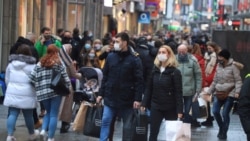 FILE: Christmas shoppers wear masks and fill Cologne's main shopping street Hohe Strasse (High Street) during the COVID-19 pandemic in Cologne, Germany, Dec. 12, 2020.