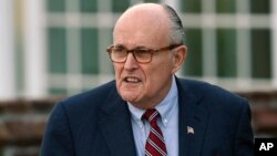 FILE - Former New York Mayor Rudy Giuliani arrives at the Trump National Golf Club Bedminster clubhouse in Bedminster, N.J., Nov. 20, 2016. President Donald Trump's new lawyer, Rudy Giuliani, said Wednesday the president repaid attorney Michael Cohen for a $130,000 payment to porn star Stormy Daniels.