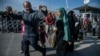 Syrian families arrive to cross into Syria from Turkey at the Cilvegozu border gate, near the town of Antakya, southern Turkey, Dec. 9, 2024. 