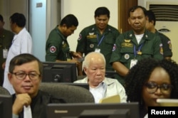 Former Khmer Rouge head of state Khieu Samphan sits in the courtroom of the Extraordinary Chambers in the Courts of Cambodia (ECCC) while awaiting a verdict on charges of genocide on November 16. He was found guilty and sentenced to life in prison. (ECCC handout via Reuters)