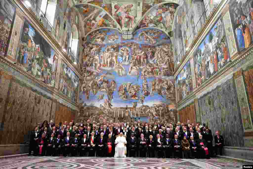 Pope Francis sits with members of the diplomatic corps accredited to the Holy See at the end of the traditional exchange of New Year greetings, in the Sistine Chapel at the Vatican.