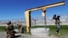 U.S. Border Patrol personnel work near a tunnel entrance between barriers separating San Diego, California, and Tijuana, Mexico. So-called 'tunnel rats' close down clandestine passages that have proliferated on the border for smuggling drugs.