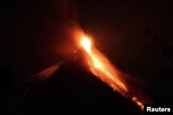 FILE - Lava flows from the Fuego volcano during an eruption as seen from Alotenango, on the outskirts of Guatemala City, Guatemala, March 2, 2016.