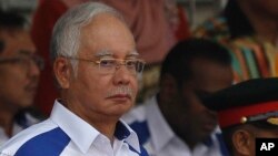 Malaysian Prime Minister Najib Razak waves the Malaysian flag during the 58th National Day celebrations at the Independence Square in Kuala Lumpur, Malaysia on Monday, Aug. 31, 2015.