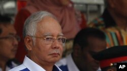 Malaysian Prime Minister Najib Razak waves the Malaysian flag during the 58th National Day celebrations at the Independence Square in Kuala Lumpur, Malaysia on Monday, Aug. 31, 2015.