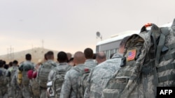 (FILES) US army soldiers queue to board a plane to begin their journey home out of Iraq from the al-Asad Air Base west the capital Baghdad, on November 1, 2011.