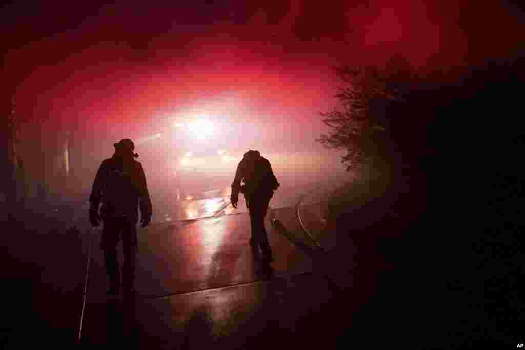 Firefighters battle the Lilac fire in Bonsall, California, Dec. 8, 2017. 