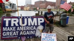 A supporter carries a rifle as he rallies for Republican presidential candidate Donald Trump at Settlers Landing Park on July 18, 2016, in Cleveland, site of the Republican National Convention.