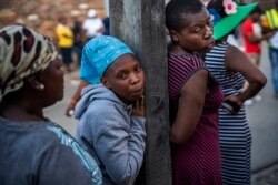 Residents of the Alexandra township in Johannesburg wait for a distribution of food organized by the municipality Wednesday, April 15, 2020 downtown Johannesburg.