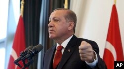 Turkey's President Recep Tayyip Erdogan addresses the country's governors at his palace in Ankara, Turkey, Thursday, Oct. 12, 2017. Erdogan lashed out against the United States for "sacrificing ties" by standing behind its ambassador in Turkey whom he bla