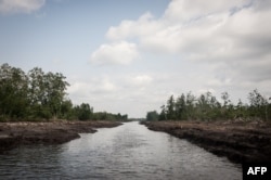 FILE - This picture taken June 8, 2016, shows a waterway in the Niger Delta.