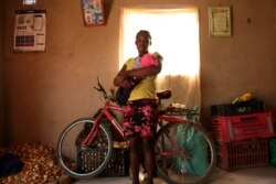 Virginia Mavhunga, a 13-year-old teenage mother, hold her child at her home in Murehwa, 80 kilometres (50 miles) northeast of Zimbabwe's capital Harare, Saturday, Dec. 11, 2021.