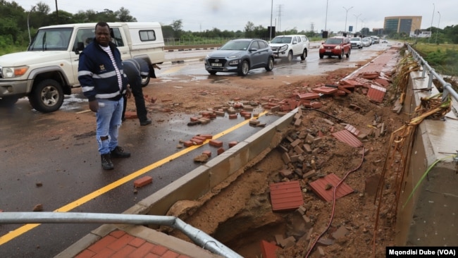 Gaborone City Council workers inspect a road damaged by the floods, in Botswana, Feb. 20, 2025.