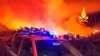 This photo released by the Italian Firefighters shows a fire near Mandas, in the south of Sardinia, Italy, in the early hours of Aug. 12, 2021.