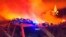 This photo released by the Italian Firefighters shows a fire near Mandas, in the south of Sardinia, Italy, in the early hours of Aug. 12, 2021.