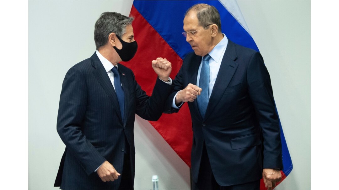 U.S. Secretary of State Antony Blinken, left, greets Russian Foreign Minister Sergey Lavrov, right, as they arrive for a meeting at the Harpa Concert Hall in Reykjavik, Iceland, May 19, 2021.