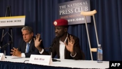 Ugandan politician Robert Kyagulanyi, better known as pop star Bobi Wine, gives a press conference with his lawyer Robert Amsterdam, left, on Sept. 6, 2018 in Washington, D.C., for the first time after being treated for beatings he allegedly received from security officers after his arrest last month in Uganda. 