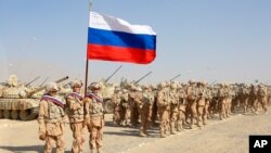FILE - Russian troops line up before the start of joint military drills with Tajikistan and Uzbekistan at the Harb-Maidon firing range about 20 kilometers north of the Tajik border with Afghanistan, in Tajikistan, Aug. 10, 2021.