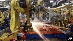 In this May 19, 2011 photo, robots weld a pre-production Chevrolet Sonic at the General Motors Orion Assembly plant in Orion Township, Michigan, USA