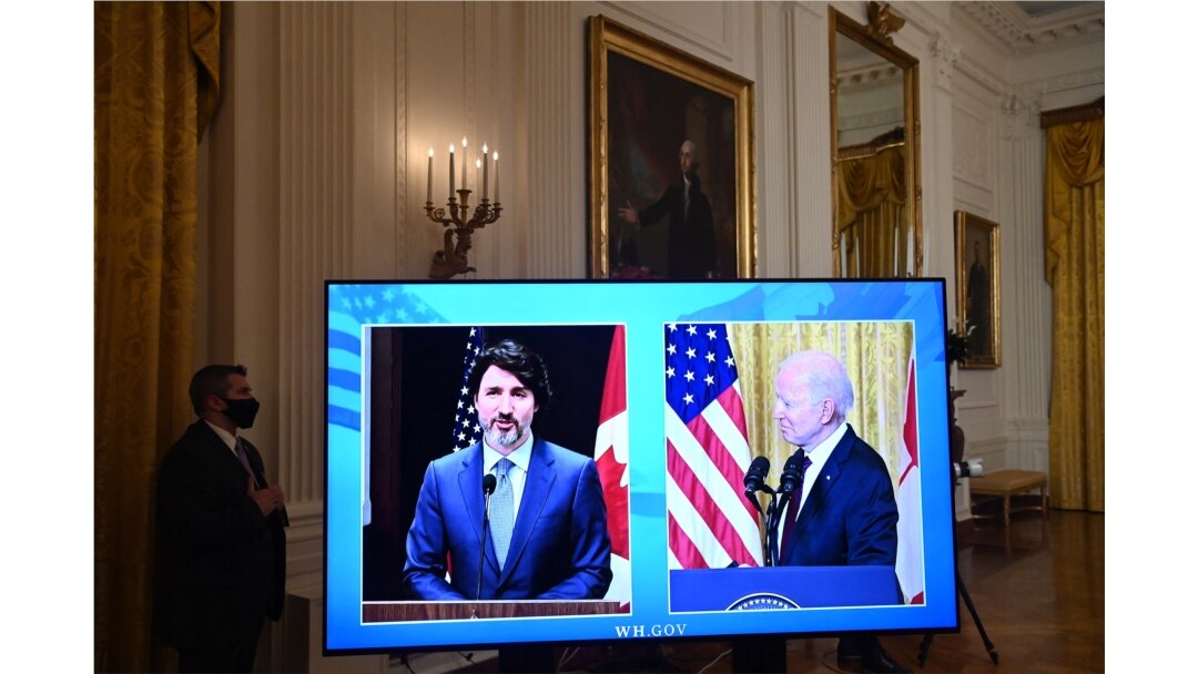 A screen shows US President Joe Biden and Canadian Prime Minister Justin Trudeau (virtual) speak to the media after holding a virtual bilateral meeting in the East Room of the White House on Feb. 23, 2021.