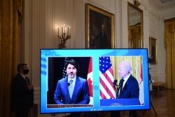 A screen shows US President Joe Biden and Canadian Prime Minister Justin Trudeau (virtual) speak to the media after holding a virtual bilateral meeting in the East Room of the White House on Feb. 23, 2021.