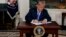 President Donald Trump signs a Presidential Memorandum on the Iran nuclear deal from the Diplomatic Reception Room of the White House, May 8, 2018.