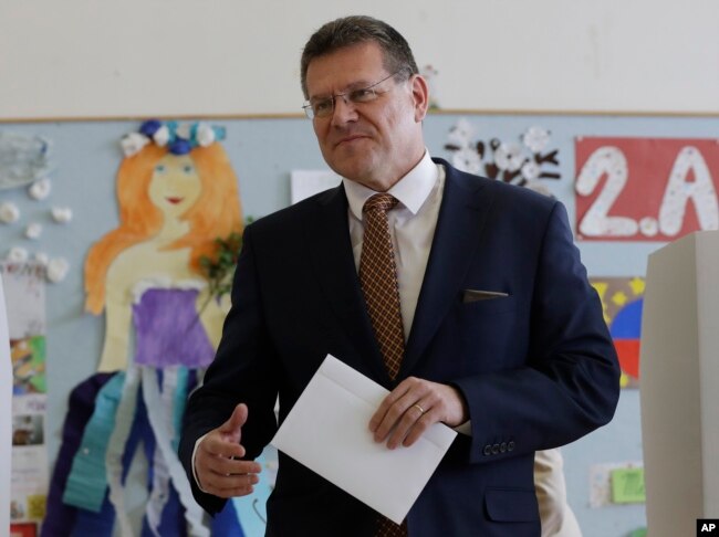 Presidential candidate and European Commission Vice President Maros Sefcovic prepares to cast his vote at a polling station during the first round of the presidential election in Bratislava, Slovakia, March 16, 2019.