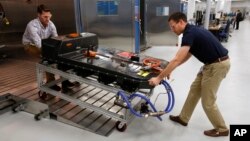 FILE- In this Nov. 4, 2016, file photo, a Chevrolet Bolt EV battery pack is removed for testing after undergoing charging and discharging cycles at General Motors Warren Technical Center's Advanced Energy Center in Warren, Mich. 