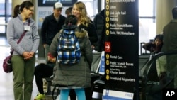 Volunteer law students talk to a traveler at a station near where international passengers arrive at Seattle-Tacoma International Airport, Feb. 28, 2017