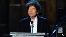 FILE - Bob Dylan accepts the 2015 MusiCares Person of the Year award at the 2015 MusiCares Person of the Year show in Los Angeles, California, Feb. 6, 2015.