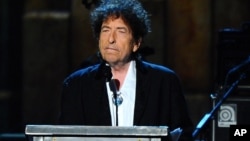 FILE - Bob Dylan accepts the 2015 MusiCares Person of the Year award at the 2015 MusiCares Person of the Year show in Los Angeles, Feb. 6, 2015.