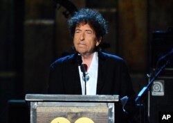 FILE - Bob Dylan accepts the 2015 MusiCares Person of the Year award at the 2015 MusiCares Person of the Year show in Los Angeles, Feb. 6, 2015.