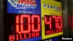 Signs display the jackpots for Mega Millions and Powerball lottery drawings at a newsstands in midtown Manhattan in New York, Oct. 19, 2018.