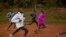 FILE: In this Jan. 30, 2016, photo winner of the London, Berlin and Chicago marathons Eliud Kipchoge, center right, trains with other athletes just after dawn in Kaptagat Forest in western Kenya. None of the persons depicted in this photo are accused of "doping."
