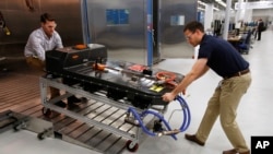 FILE- A Chevrolet Bolt EV battery pack is removed for testing after undergoing charging and discharging cycles at General Motors Warren Technical Center's Advanced Energy Center in Warren, Mich. Taken Nov. 4, 2016.