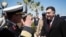FILE - This image released by the media office of the unity government shows Fayez al-Sarraj, right, upon his arrival in Tripoli, Libya, March 30, 2016. He arrived by sea with six deputies to set up a temporary seat of power in a naval base.