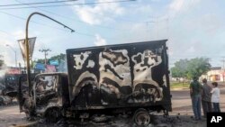 A burned-out truck used by gunmen smolders in an intersection, a day after street battles between gunmen and security forces in Culiacan, Mexico, Oct. 18, 2019. 