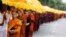 Buddhist monks walk down a road asking for alms during the annual Vesak festival, in Colombo, Sri Lanka, May 11, 2017. 
