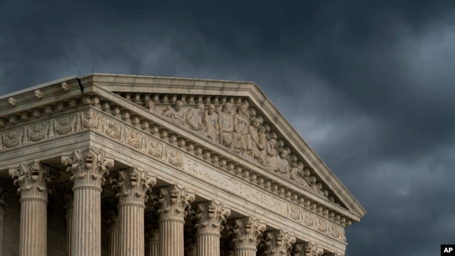 FILE - The Supreme Court building is seen under stormy skies in Washington, June 20, 2019.