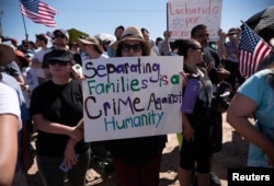 People participate in a protest against the U.S. immigration policy of separating children from their families when they enter the United States as undocumented immigrants, outside the Tornillo Transit Center, in Tornillo, Texas, June 17, 2018.