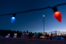 Holiday lights are displayed on a drive-thru route at the Cumberland Fair Grounds, Tuesday, Dec. 14, 2021, in Cumberland, Maine. (AP Photo/Robert F. Bukaty)